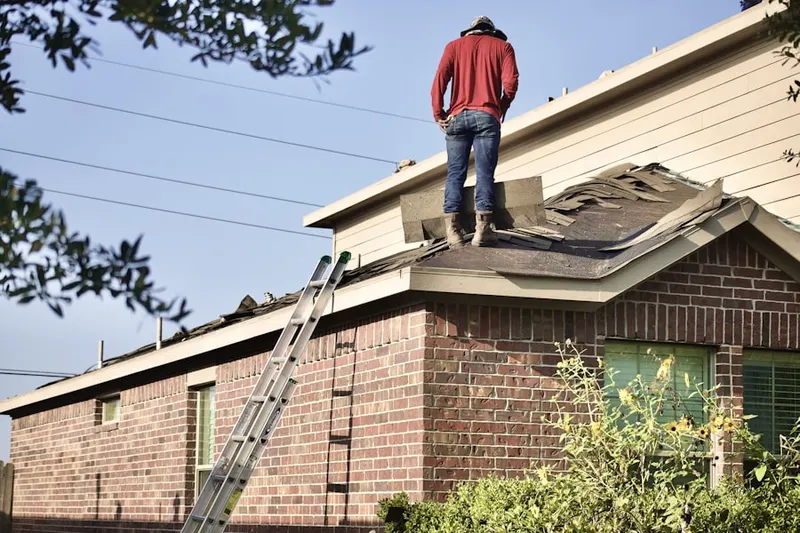 Professional roofer working on a residential roof in East Garden City